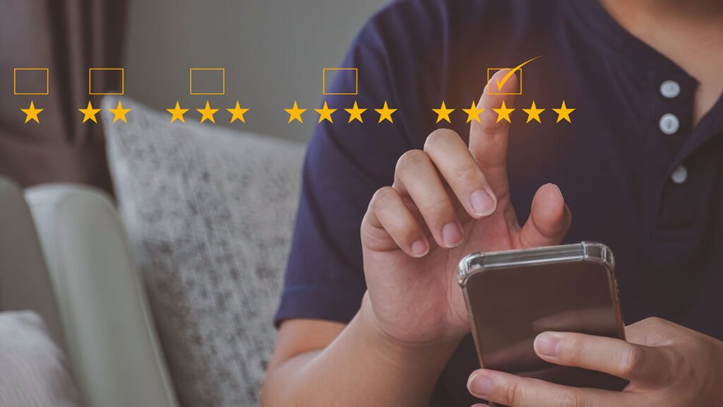A man using a smartphone with a star rating on it.
