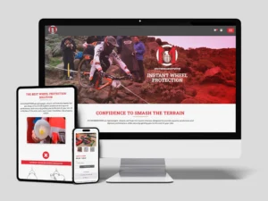 A computer, tablet, and smartphone display a website about instant wheel protection, featuring an image of mountain bikers and the slogan "Confidence to Smash the Terrain.